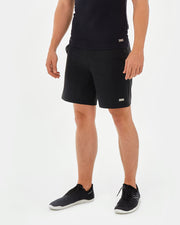 black sustainable mens shorts made from recycled plastic. with a metal plaque wave logo design