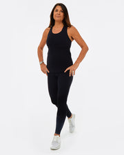 womens sustainable gymwear set. Black vest top with black leggings made from recycled plastic.