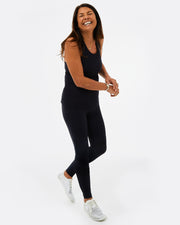 womens gymwear set. Black vest top with black leggings, with mesh paneling made from recycled plastic. 