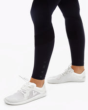 black sustainable gym leggings with mesh paneling with KAMI branding 
