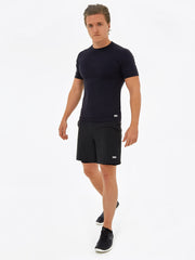 man wearing matching black sustainable activewear set. Black t-shirt made from recycled plastic with 2 layer supportive shorts, sustainable gymwear for men