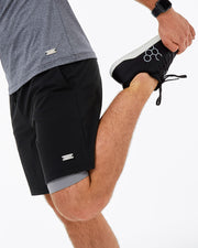 mens sustainable gymwear. Grey top made from recycled plastic with matching shorts, grey supportive under layer and black outer layer.