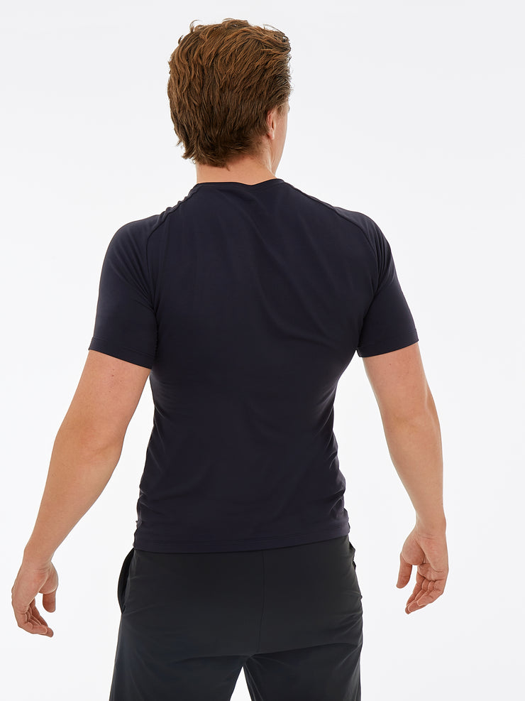 back of a man wearing a black gym top and black shorts